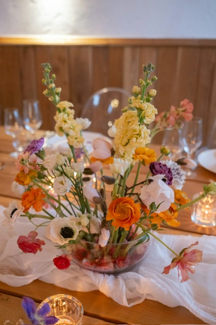 Garden celebration with colorful florals and curated tableware