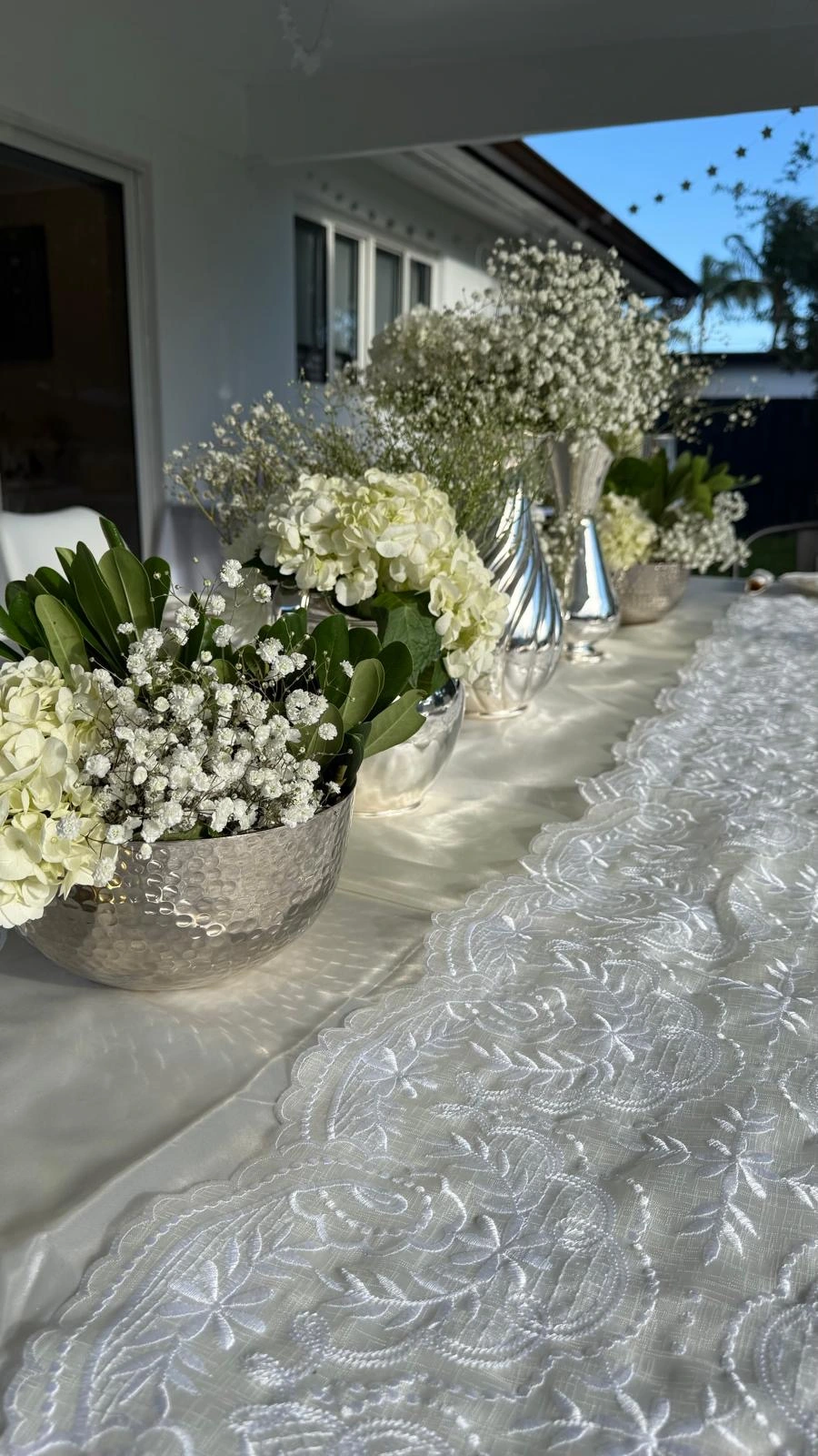Luxury floral tablescape with white lace and silver accents